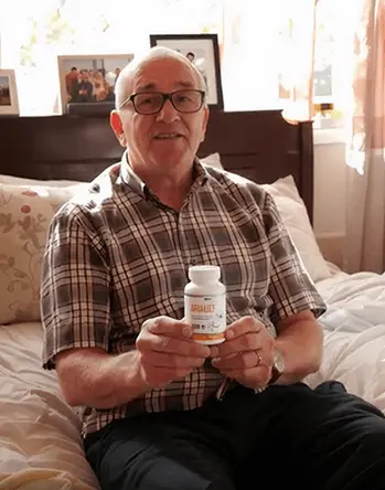Robert from Columbus Ohio holding Arialief bottle